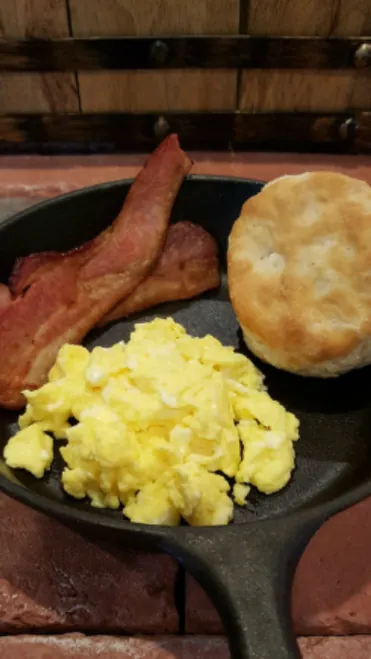 Catered office breakfast with bacon, scrambled eggs, biscuits and fresh fruit